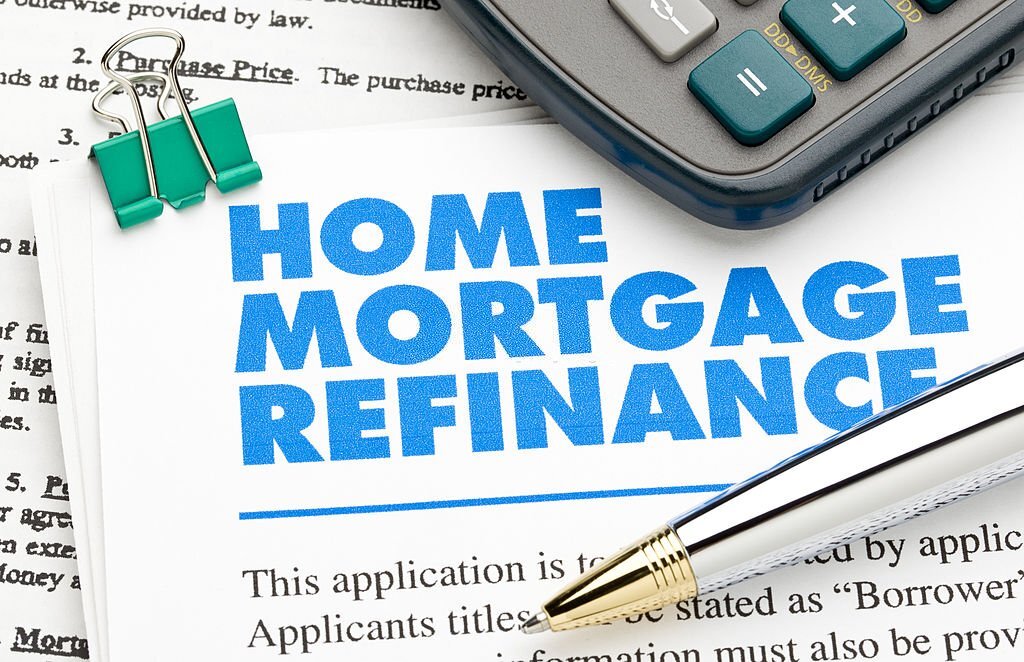 Home Mortgage Refinance Application and pen and calculator.